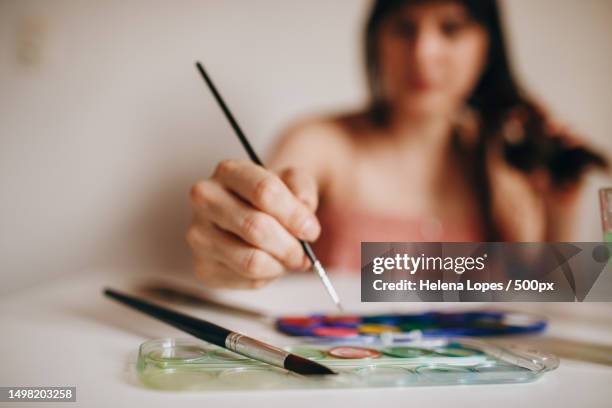 portrait of a young woman painting on paper at table at home,belo horizonte,state of minas gerais,brazil - aquarela stock pictures, royalty-free photos & images