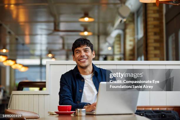 man using laptop in cafe - man looking away stock pictures, royalty-free photos & images