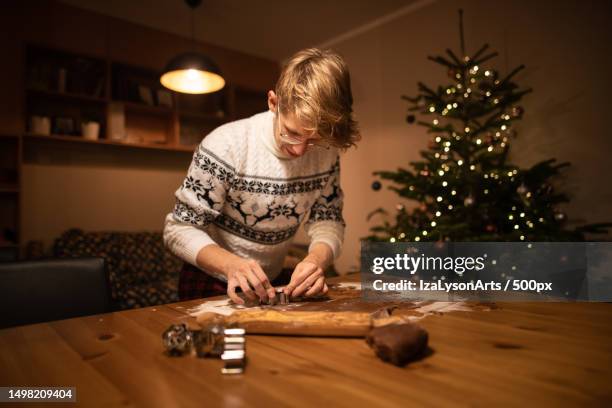 young man is making homemade cookies,poland - man baking cookies stock pictures, royalty-free photos & images