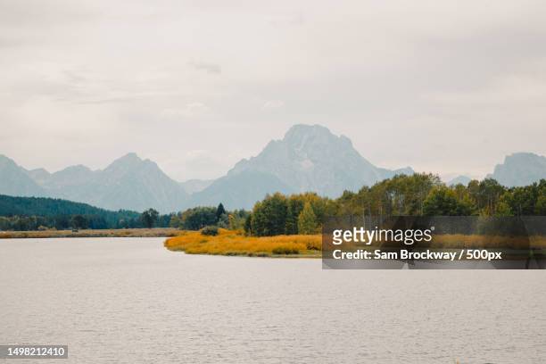 scenic view of lake against sky - oxbow bend stock pictures, royalty-free photos & images