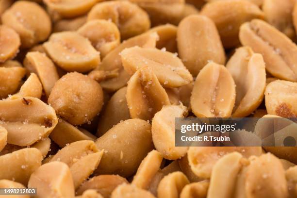 large amount of peeled salted peanuts - peanut stock pictures, royalty-free photos & images