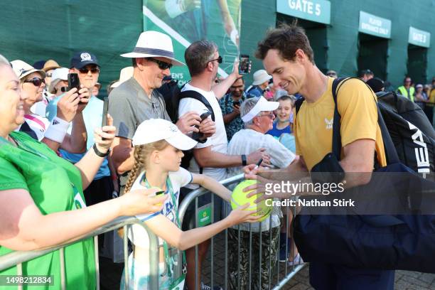 Andy Murray of Great Britain signs autographs for fans after winning the Men's Singles Round of 32 match against Joris De Loore of Belgium during Day...