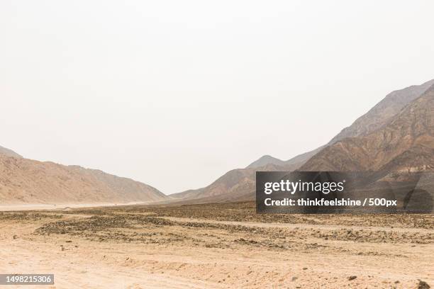 scenic view of desert terrain against foggy mountain sky,peru - inkas stock pictures, royalty-free photos & images