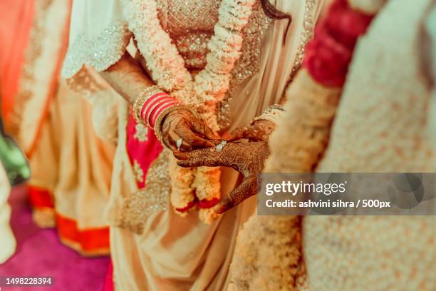 cropped hands of bride and groom couple with henna on hands in traditional clothing,wedding ceremony ritual,india - hindu wedding ceremony stock pictures, royalty-free photos & images