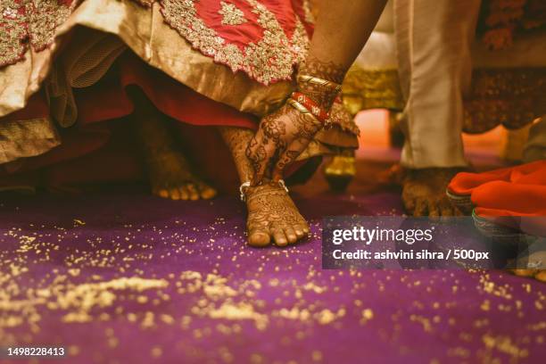 cropped hands of bride and groom couple with henna on hands and feet in traditional clothing,wedding ceremony ritual,india - wedding feet fotografías e imágenes de stock