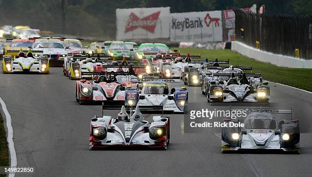 Lucas Luhr of Germany and driver of the pole sitting Muscle Milk Team Pickett HPD and Guy Smith of England and driver of the Dyson Racing Lola Mazda,...