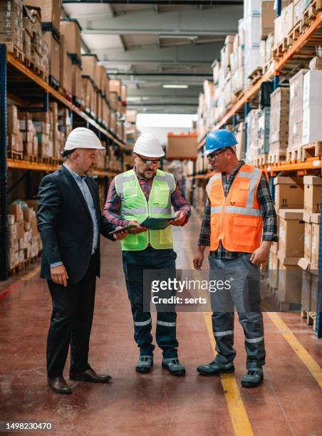 manager and factory employees work together to get the job done - workflow efficiency stock pictures, royalty-free photos & images