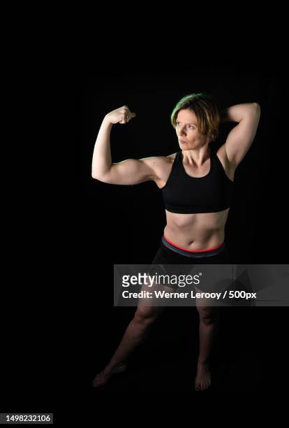 Premium Photo  Sports workout and woman flexing back in studio isolated on  a black background strong flex muscle and female athlete with bicep arm  strength or bodybuilder training fitness and healthy