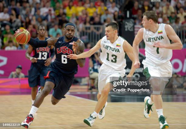 Lebron James of the United States with Sarunas Jasikevicius and Martynas Pocius of Lithuania during the Men's Basketball Preliminary Round match...