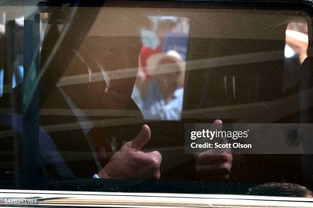 Former President Donald Trump gives a thumbs up as he departs the Wilkie D. Ferguson Jr. Federal courthouse following his arraignment on June 13,...