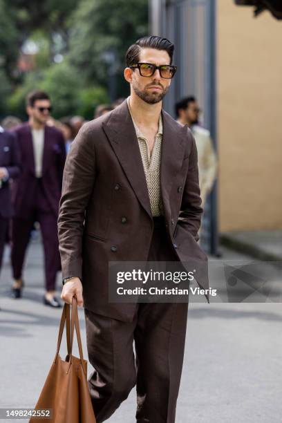 Guest wears brown suit during Pitti Immagine Uomo 104 on June 13, 2023 in Florence, Italy.