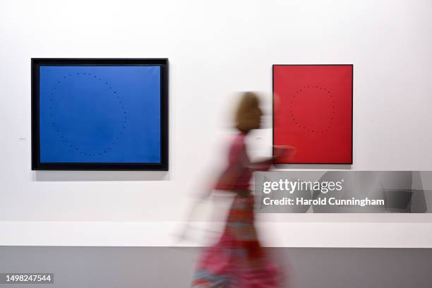 Visitor walks past the artworks of Lucio Fontana "Concetto Spazaile", 1961 on June 13, 2023 in Basel, Switzerland. Art Basel is one of the most...