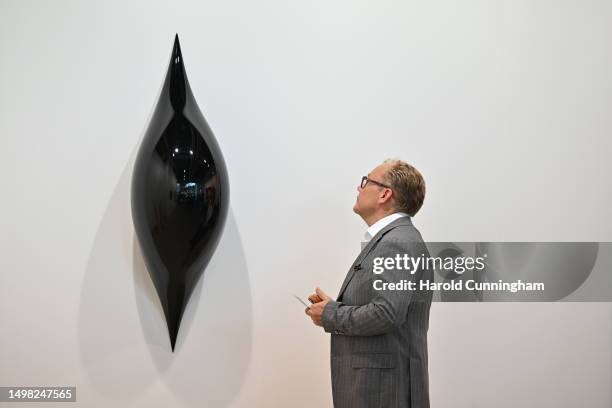 Visitor looks at the artwork of Anish Kapoor "Untitled", 2022 on June 13, 2023 in Basel, Switzerland. Art Basel is one of the most prestigious art...