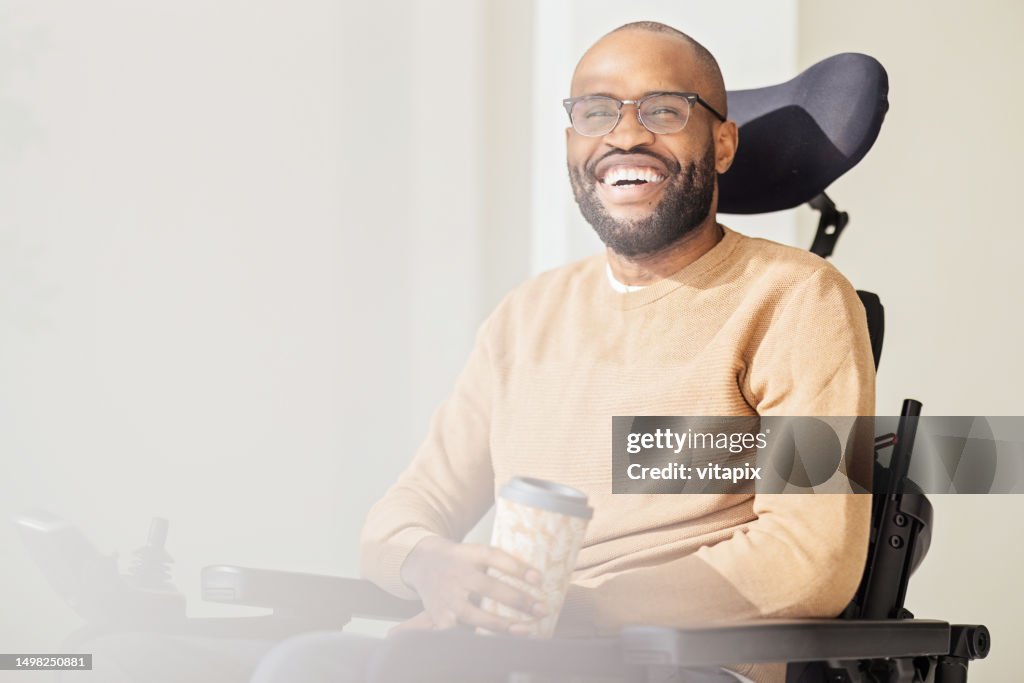 Disabled Black Man Using Smartphone at Home