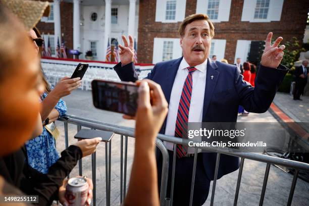 Businessman and election conspiracy theorist Mike Lindell talks with reporters outside the club house at the Trump National Golf Club hours ahead of...