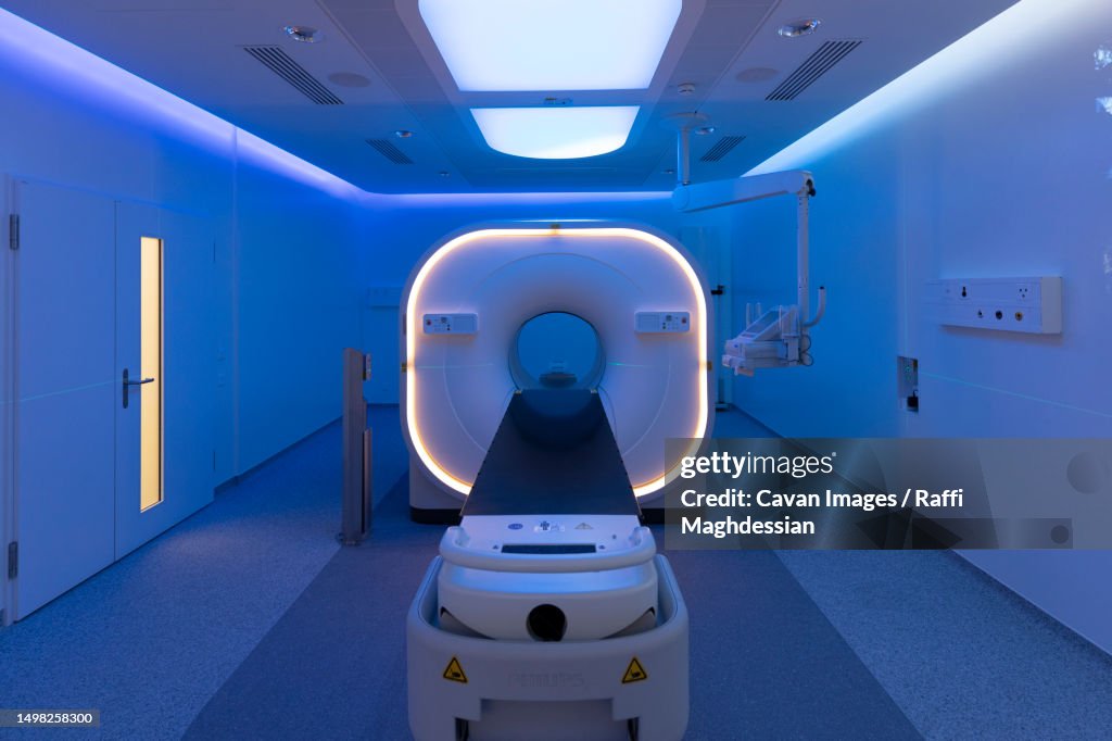View of a scanner room bathed in blue light