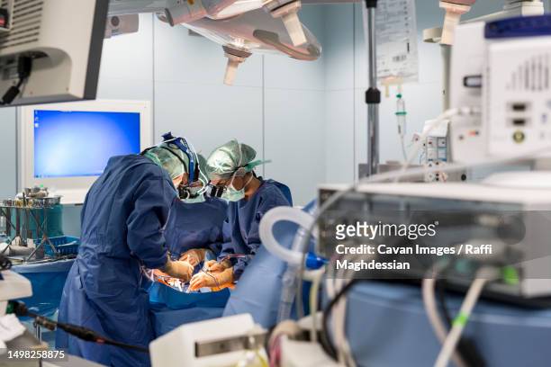 two cardiac surgeons operate on a patient - heart surgery stock pictures, royalty-free photos & images