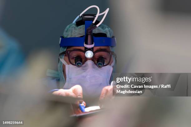 cardiac surgeon operating on a heart - laparoscopic surgery ストックフォトと画像