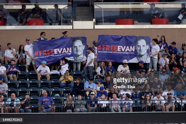Friends of detained Wall Street Journal reporter Evan Gershkovich are seen holding a #FreeEvan banner in support in the third inning of the game...