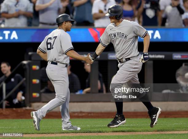 LeMahieu of the New York Yankees is congratulated by third base coach Luis Rojas after LeMahieu hit a two run home run in the fourth inning against...