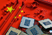 Republic of China flag on a red painted PC motherboard with some processors on it. Concept for supremacy in global microchip and semiconductor manufacturing. Italy