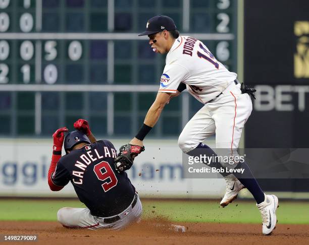 Mauricio Dubon of the Houston Astros tags out Jeimer Candelario of the Washington Nationals attempting top steal second base in the fourth inning at...