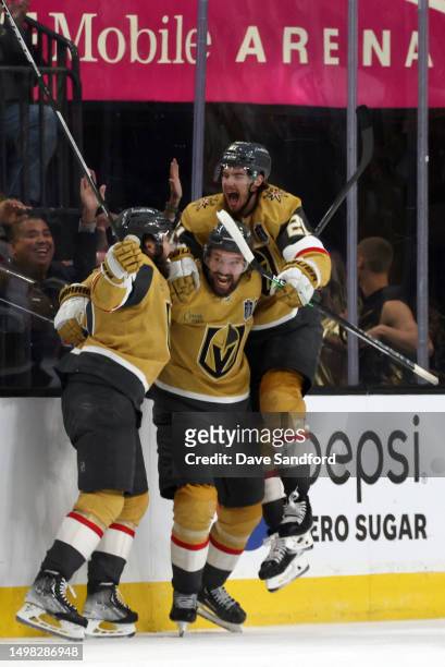 Mark Stone of the Vegas Golden Knights celebrates with teammates Chandler Stephenson and Brett Howden after Stone scored his second goal of the game...
