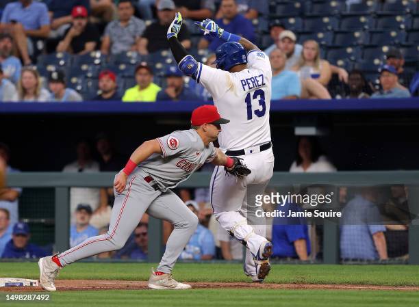 Salvador Perez of the Kansas City Royals is tagged out at first by Spencer Steer of the Cincinnati Reds during the game at Kauffman Stadium on June...