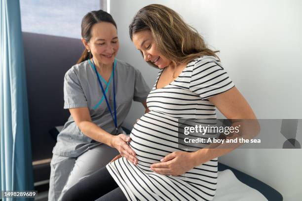 expectant mother receiving test results - midwifery stock pictures, royalty-free photos & images