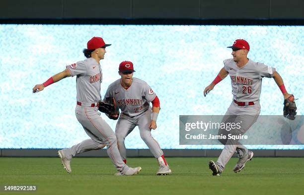 Stuart Fairchild, TJ Friedl and T.J. Hopkins of the Cincinnati Reds celebrate after the Reds defeated the Kansas City Royals 5-4 to win the game at...