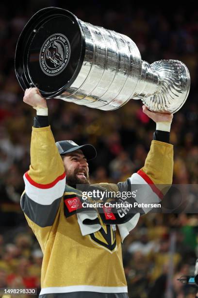Adin Hill of the Vegas Golden Knights hoists the Stanley Cup after defeating the Florida Panthers to win the championship in Game Five of the 2023...