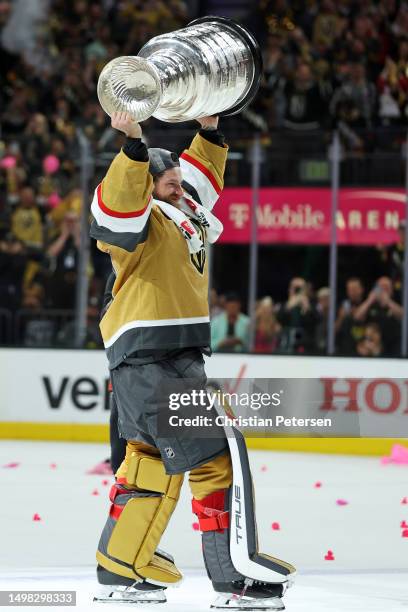 Adin Hill of the Vegas Golden Knights hoists the Stanley Cup after defeating the Florida Panthers to win the championship in Game Five of the 2023...