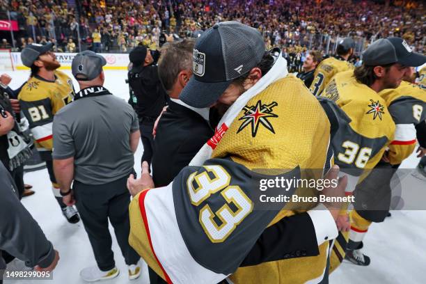 Head coach Bruce Cassidy hugs Adin Hill of the Vegas Golden Knights after defeating the Florida Panthers to win the championship in Game Five of the...