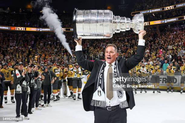 Head coach Bruce Cassidy of the Vegas Golden Knights hoists the Stanley Cup after defeating the Florida Panthers to win the championship in Game Five...