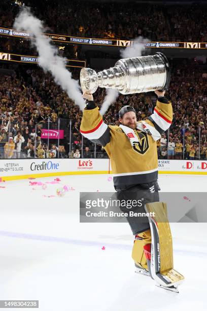 Laurent Brossoit of the Vegas Golden Knights hoists the Stanley Cup after defeating the Florida Panthers to win the championship in Game Five of the...