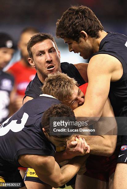 Brock McLean of the Blues tackles Luke Parker of Swans during the round 19 AFL match between the Carlton Blues and the Sydney Swans at Etihad Stadium...