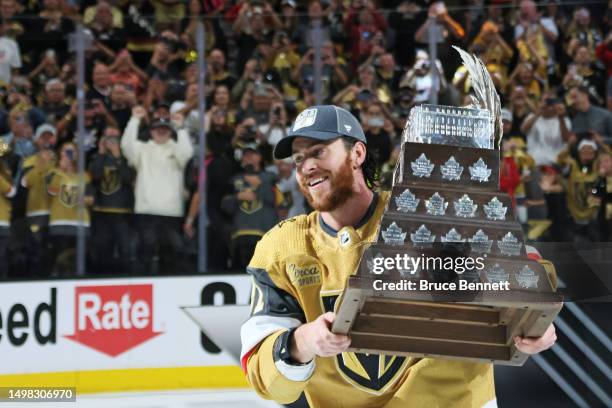 Jonathan Marchessault of the Vegas Golden Knights hoists the Conn Smythe Trophy after a championship win against the Florida Panthers in Game Five of...