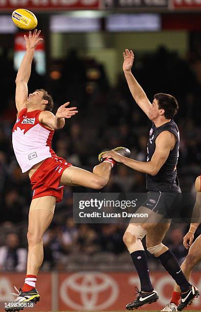 Matthew Kreuzer of the Blues and Shane Mumford of the Swans contest in the ruck during the round 19 AFL match between the Carlton Blues and the...