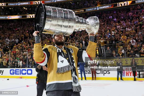 Brayden McNabb of the Vegas Golden Knights hoists the Stanley Cup after a win against the Florida Panthers in Game Five of the 2023 NHL Stanley Cup...