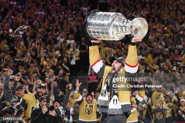 Mark Stone of the Vegas Golden Knights hoists the Stanley Cup following their victory over the Florida Panthers in Game Five of the 2023 NHL Stanley...