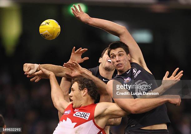 Matthew Kreuzer of the Blues and Shane Mumford of the Swans contest for a mark during the round 19 AFL match between the Carlton Blues and the Sydney...