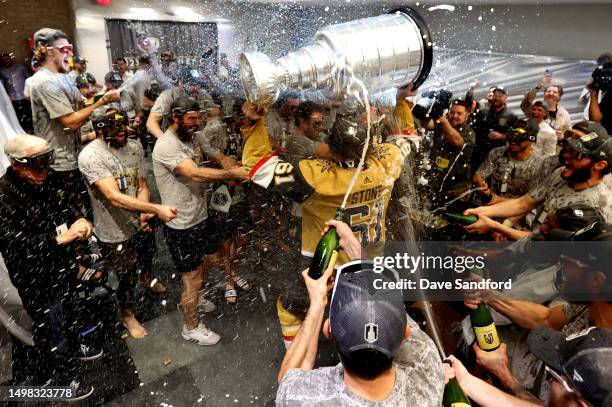 Mark Stone of the Vegas Golden Knights brings the Stanley Cup into the locker room after Game Five of the 2023 NHL Stanley Cup Final between the...