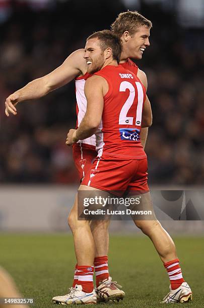 Luke Parker and Ben McGlynn of the Swans celebrate a goal during the round 19 AFL match between the Carlton Blues and the Sydney Swans at Etihad...