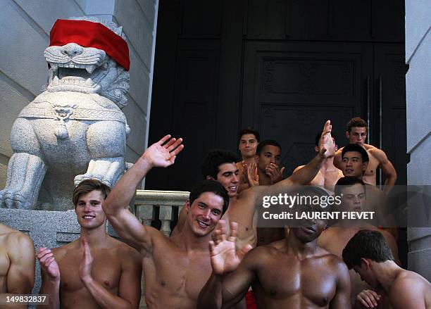Group of topless male models waves to a crowd of onlookers outside the soon to open Abercrombie & Fitch flagship clothing store in Hong Kong on...