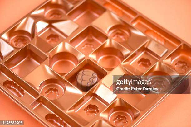 one chocolate left - close up of chocolates for sale fotografías e imágenes de stock