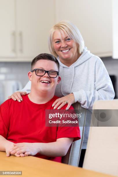 mother and son portrait at home - down syndrome stock pictures, royalty-free photos & images