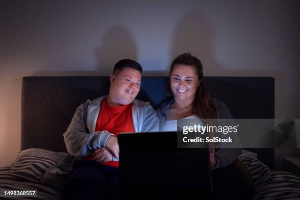 enjoying a film at home - disability computer stock pictures, royalty-free photos & images
