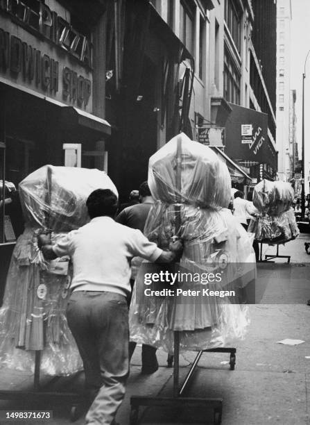 Person Pushing Garment Rack Clothes Rack Street Photos and Premium High Res Pictures - Getty Images