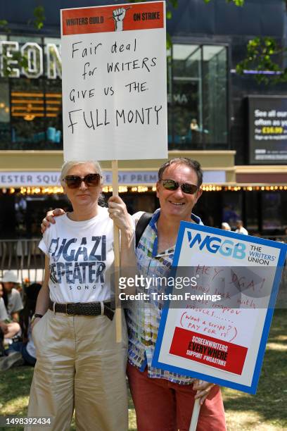 Alice Nutter and Simon Beaufoy hold placards as the Writers Guild Of Great Britain joins a global strike in solidarity with the Writers' Guild of...
