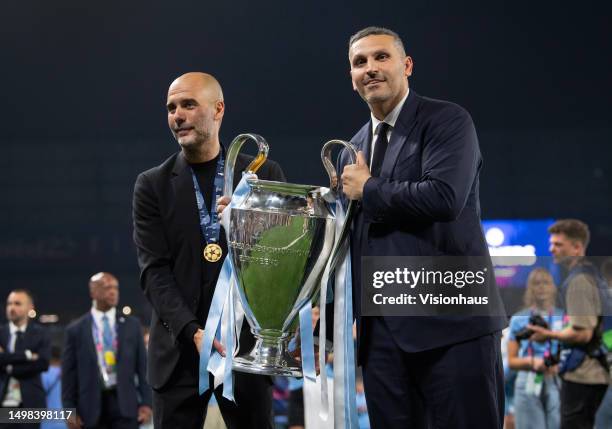 Manchester City chairman Khaldoon Al Mubarak celebrates with manager Pep Guardiola and the trophy after the UEFA Champions League 2022/23 final match...